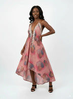 Flowing hem of the boho pink maxi dress in the wind.