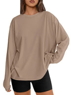 Woman wearing oversized white long sleeve crewneck with baggy cargo pants Y2K style